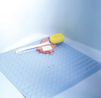 Photo of square Nonskid bath and shower mat with washcloth, back sponge & soap set in corner